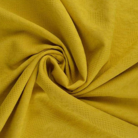 Bomuldsjacquard i farven gul, med vaffelstruktur og blomstermotiv, metervare til erhverv (billede 1 af 5)